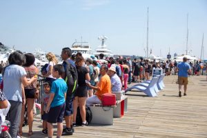 A summer crowd enjoying the HarborWalk