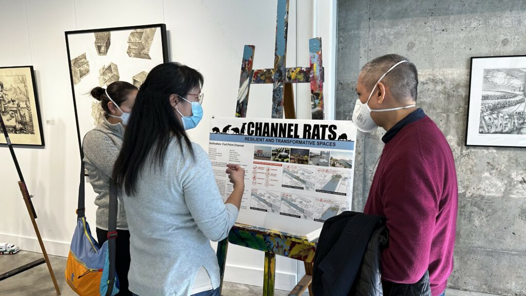 workshop participants discuss a presentation board